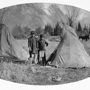 Cover image of Stoney Nakoda boys and playhouse teepees (5 feet high) [at Kootenay Plains, Alberta]