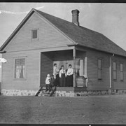 Cover image of Family on porch of house, [North Dakota?]