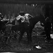 Cover image of Elliott Barnes and unidentified woman packing horse