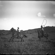 Cover image of Elliott and Robert Barnes roping horses at Jumping Pound