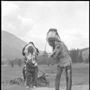 Cover image of Unknown man and John Hunter (Îhre Wapta) (Dry River Rocks) golfing at Banff Springs Hotel golf course