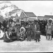 Cover image of Ben Kaquitts (Mînâ Yuha Wagicha) (Dances with Sword) and Janet (Maraha) Kaquitts standing far left, Mark Poucette far right