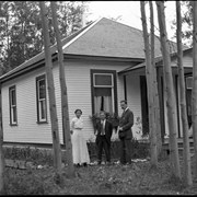 Cover image of [Unidentified people standing outside house]