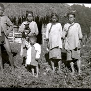 Cover image of [Adults and child in front of hut]