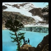 Cover image of [Two people and dog at Lake of the Hanging Glacier]