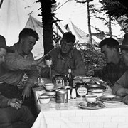 Cover image of Johnny Musk, Bill Bagley, and the three DeMotts at camp table