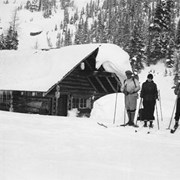 Cover image of Pat, Dell, and Jim Brewster at Sunshine cabin on skis