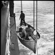 Cover image of People being lowered in lifeboat