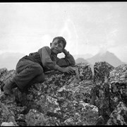 Cover image of Elliott Barnes Jr. on summit of Elliot Peak