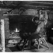 Cover image of Elliott Barnes in front of fireplace at his Kootenay Plains cabin