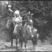Cover image of Unknown woman and child in regalia on horseback