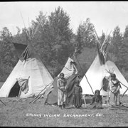 Cover image of Unknown women and children by tipis