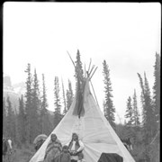 Cover image of Unknown family standing by teepee