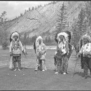 Cover image of  John Hunter (Îhre Wapta) (Dry River Rocks), Mark Poucette, and 2 unknown men golfing at Banff Springs Hotel golf course

