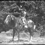 Cover image of Unknown child in regalia on horse