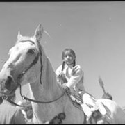 Cover image of Unidentified child on horse in parade