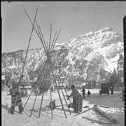 Cover image of Unidentified people setting up a tepee on Banff Avenue