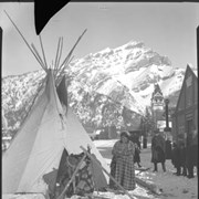 Cover image of Unidentified people setting up tepee on Banff Avenue