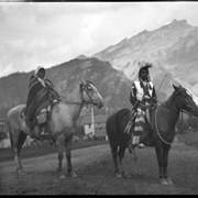 Cover image of Unidentified man and woman on horses, posing on Banff Avenue