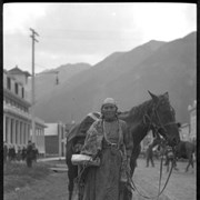 Cover image of Unidentified woman with horse on Banff Avenue