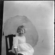 Cover image of Little girl sitting in chair