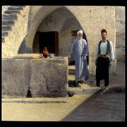 Cover image of [Two men outside stone building]