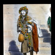 Cover image of 
[Man with painted face dressed in garlands]