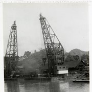 Cover image of 
[Two cranes in boatyard on water]