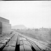 Cover image of Looking west at Fort William showing grain elevator and grain cars