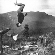 Cover image of Jim Brewster with Phil Moore doing acrobatics, Brewster Brothers party trip to Yellowhead Pass, 1904