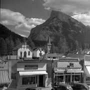 Cover image of Rundle and Cascade and Banff Avenue from store roof. -- 1938 Aug.
