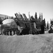 Cover image of Snowmobile, Sunshine, Nr. Lodge with skiis on back. -- [1950]