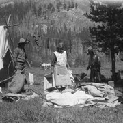 Cover image of [Guests and cook at cook tent in camp]