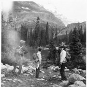 Cover image of [Catharine Robb Whyte with two unidentified people with hiking packs on next to lake]