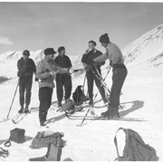 Cover image of [Catharine Whyte and Peter Whyte eating on skis with group]