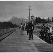 Cover image of [Men standing on platform next to railway tracks]