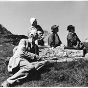 Cover image of [Group seated around rock]