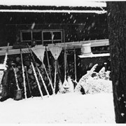 Cover image of [Gardening implements against building in snow]