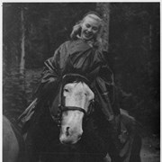 Cover image of [Unidentified woman on horseback in rain poncho]