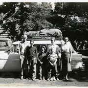 Cover image of [Unidentified group standing in front of vehicle]