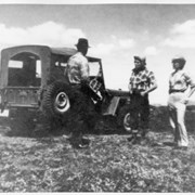 Cover image of Three unidentified people with jeep - blurry