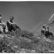 Cover image of Three people seated on mountain