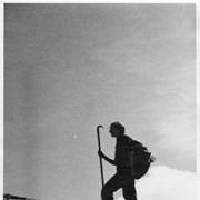 Cover image of Hiker with walking stick on ridge