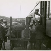 Cover image of Unidentified men loading train