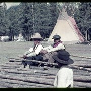 Cover image of Unidentified Indigenous men seated on piled poles