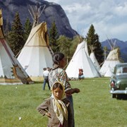 Cover image of Woman and girl in front of tepees